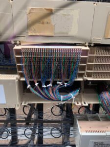 Fiber duct junction above equipment frames
